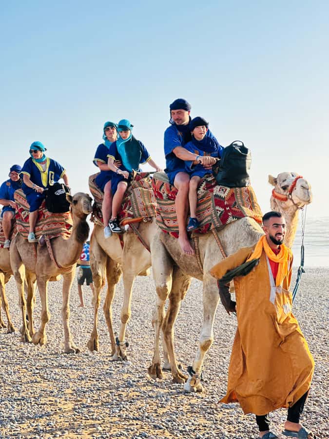 Agadir/Taghazout : Sandboarding & Sunset Camel Ride with BBQ - Nomad attire and camel riding at sunset, with that ocean glow