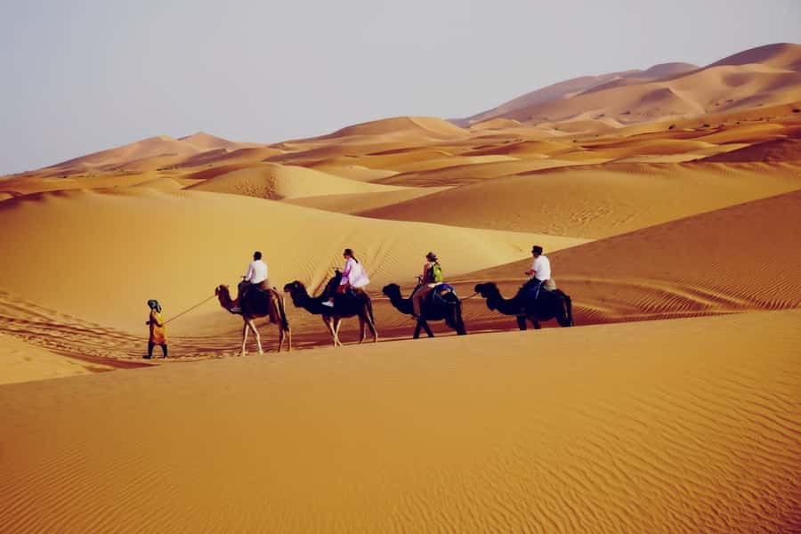 From Merzouga: Desert Overnight in Heated Tent & Camel Ride - Day 1: camel ride, sunset timing, and sandboarding
