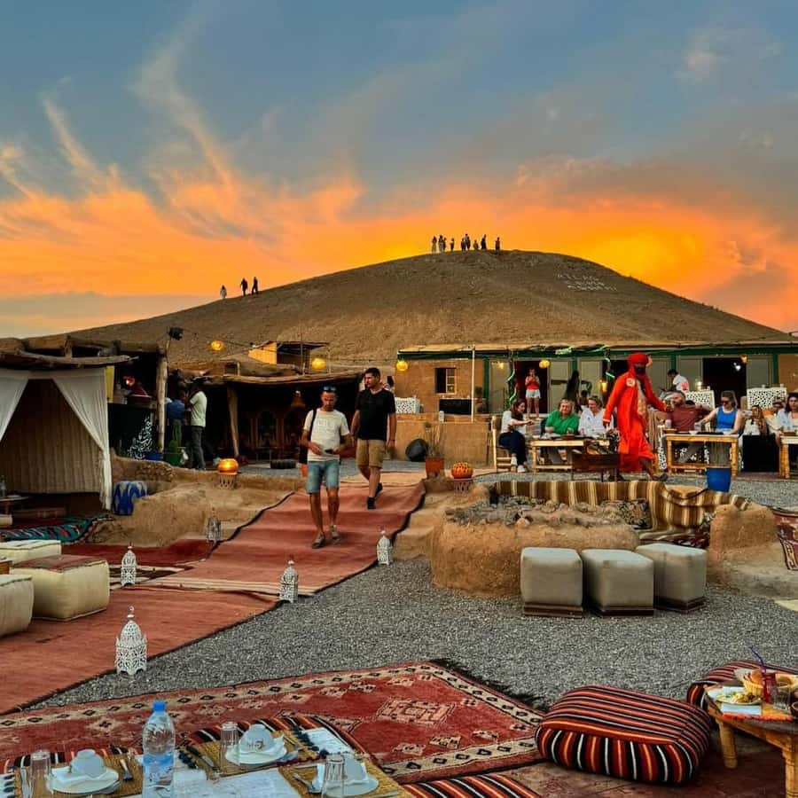 Marrakech: Desert Tour with Dinner, Show and Camel Ride - Riding a camel on rocky dunes: sunset timing and what to expect